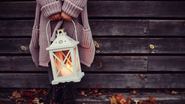 Autumn leaves and a child with lantern